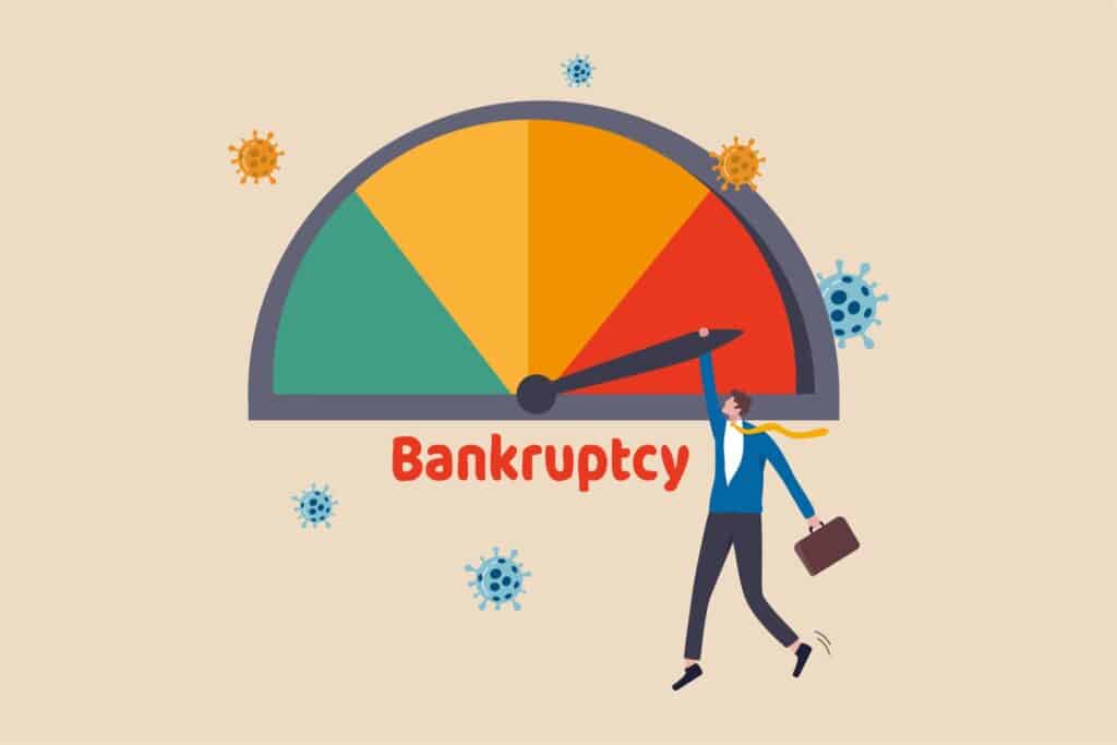 A person hanging on an arrow pointed at bankruptcy in red