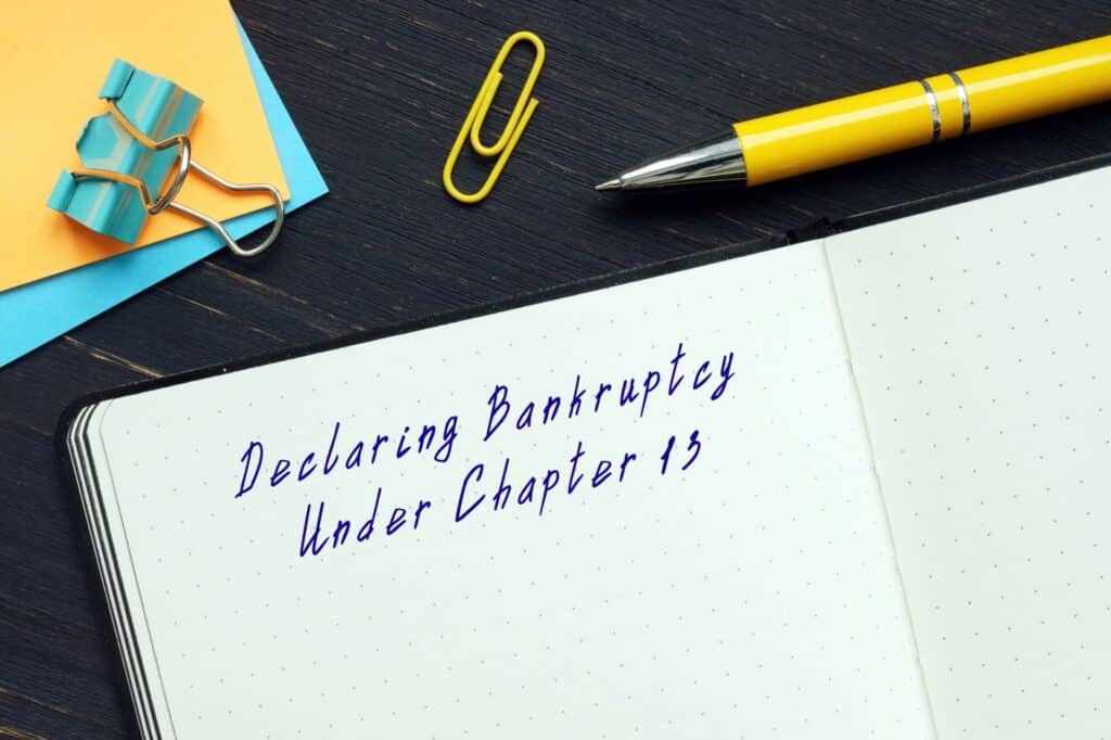A note book that says declaring bankruptcy under chapter 13