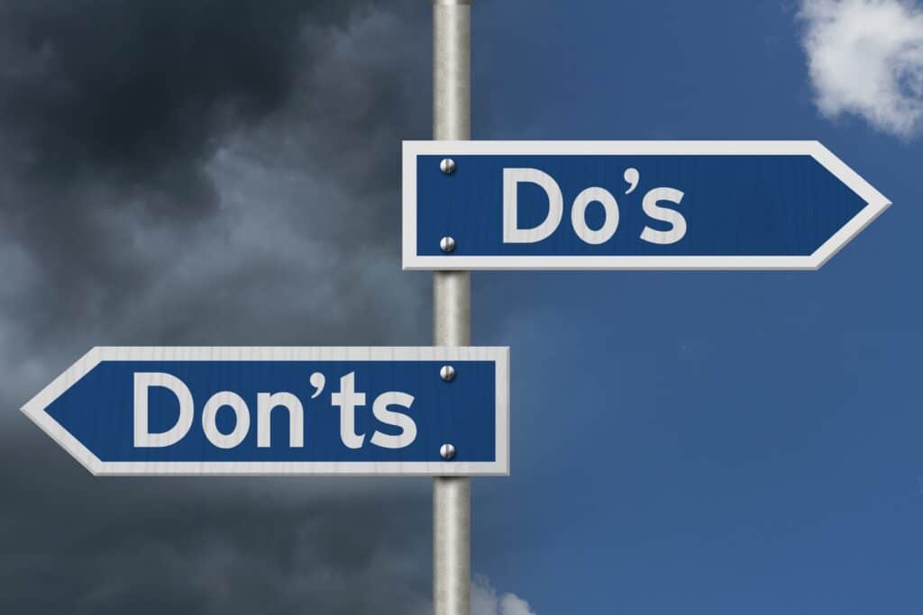 Do’s and Don’ts blue highway road sign with a blue and stormy sky
